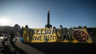 Protesters hold a banner reading "Freedom of Movement for all" during a demonstration for the evacuation of all migrant camps in Greece after the fire at the Moria refugee camp on Lesbos, on September 20, 2020 in Berlin. (Photo by STEFANIE LOOS / AFP) (Photo by STEFANIE LOOS/AFP via Getty Images)